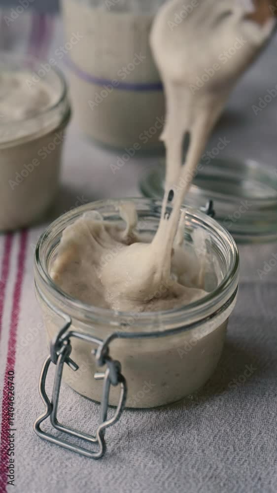 Sourdough starter in a jar, baking sourdough bread Sourdough starter in a jar, baking sourdough bread