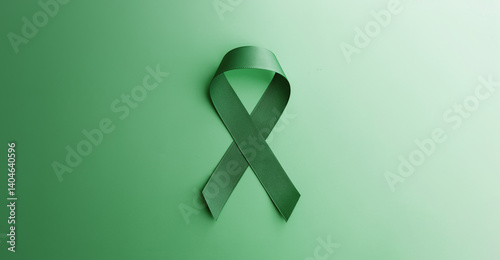 Mental Health Awareness Concept. Self Care, Positive Thinking, Happy and Optimistic Mind. a Green Ribbon lay on Green background. Table top view