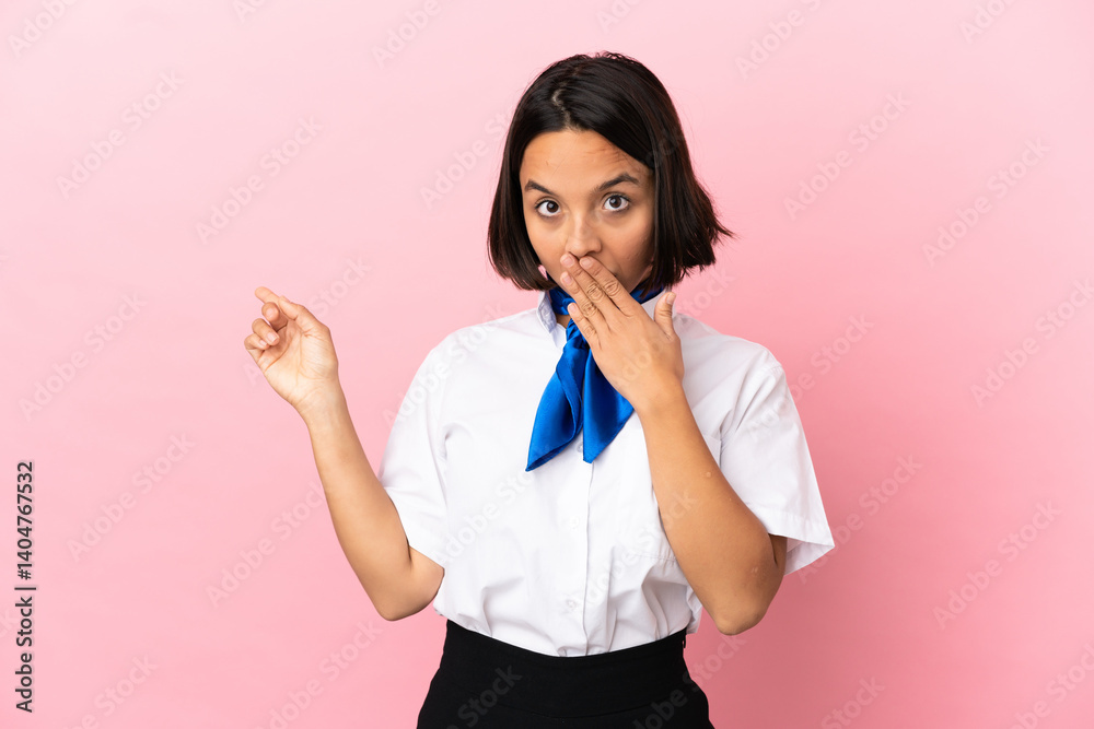 Airplane stewardess over isolated background with surprise expression while pointing side Airplane stewardess over isolated background with surprise expression while pointing side
