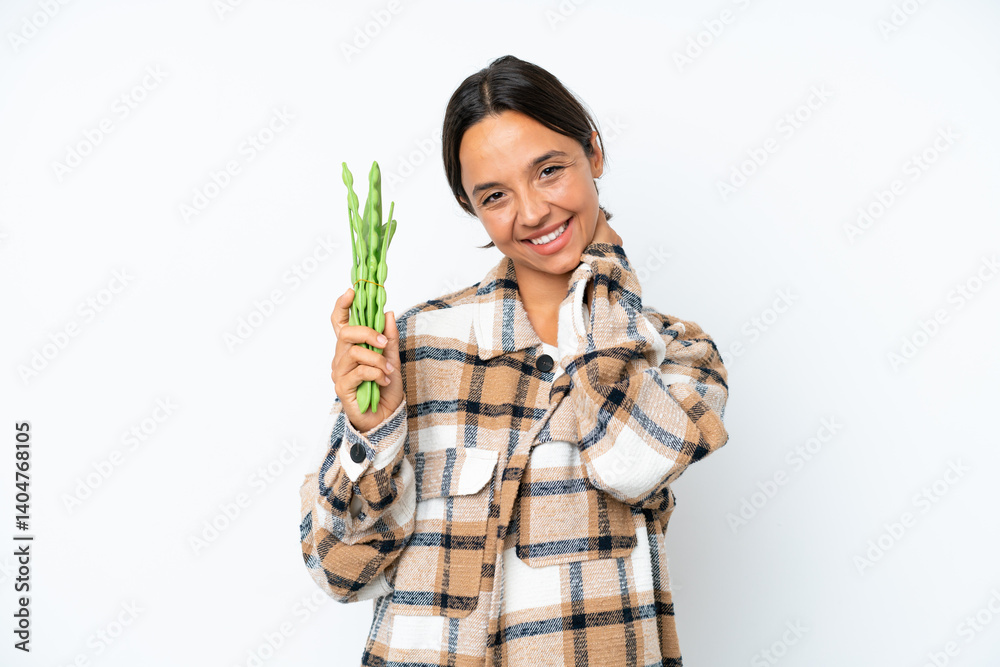 Young hispanic woman holding a green beans isolated on white background laughing Young hispanic woman holding a green beans isolated on white background laughing