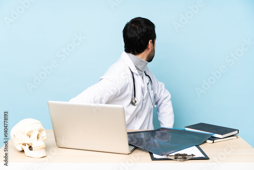 Professional traumatologist in workplace in back position