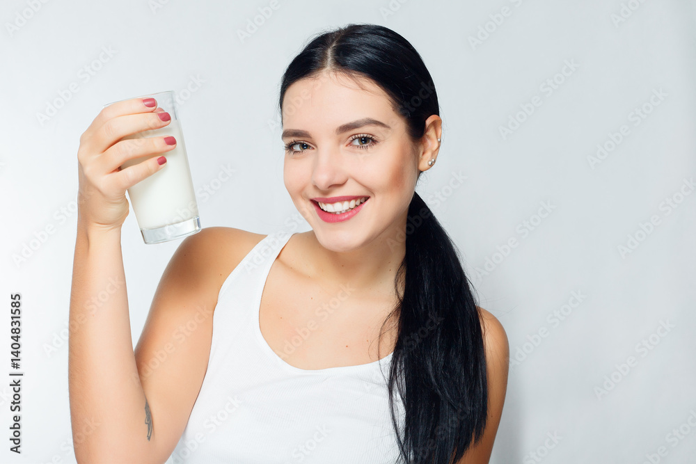 Milk - Woman drinking milk, happy and smiling beautiful young woman Milk - Woman drinking milk, happy and smiling beautiful young woman