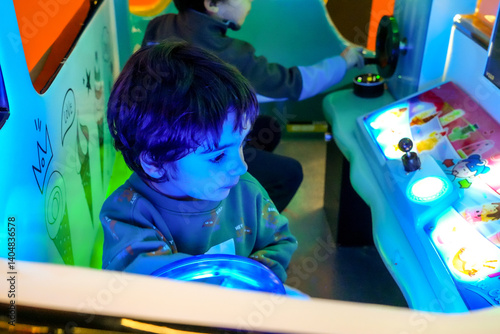 Obraz na płótnie Child playing driving simulator in arcade game center w salonie