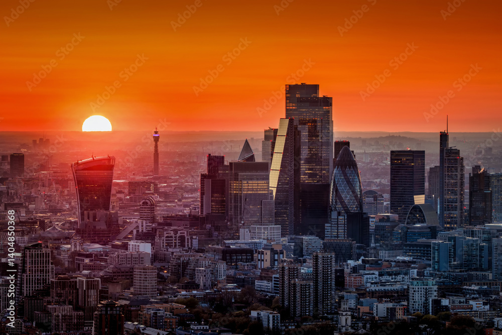 Elevated view of a fiery sunset behind the urban skyline of the City of London, England