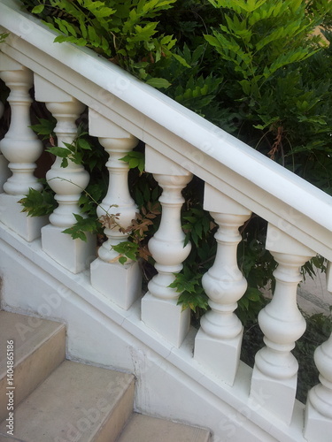 Obraz na płótnie White stairs with green plants on the wall, closeup of photo w salonie