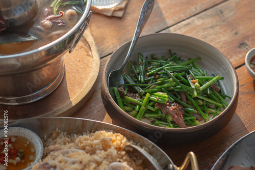 Stir-fry Pork Liver with Chinese Chives serve on wood table.