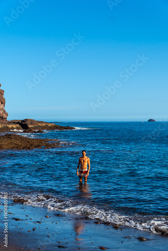 Obraz na płótnie Tourist enjoying the clear water of tufia beach in gran canaria, spain w salonie