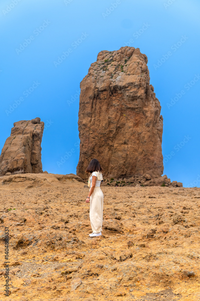 Tourist enjoying roque nublo monolith in gran canaria, spain