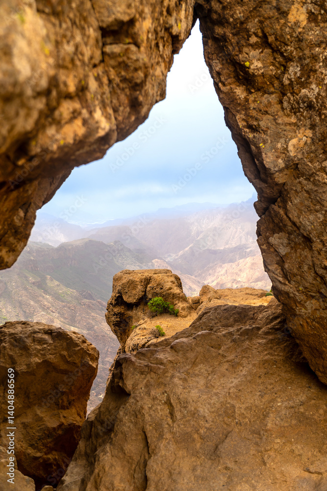 Hiking in gran canaria, roque nublo volcanic rock formations framing mountain view