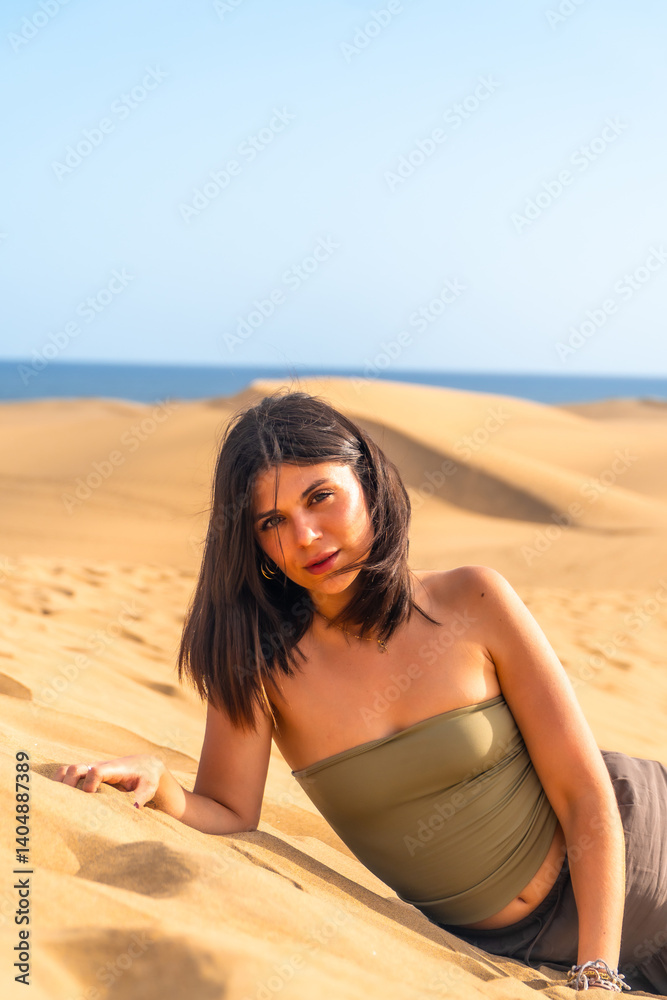 Tourist relaxing on the maspalomas dunes in gran canaria, spain