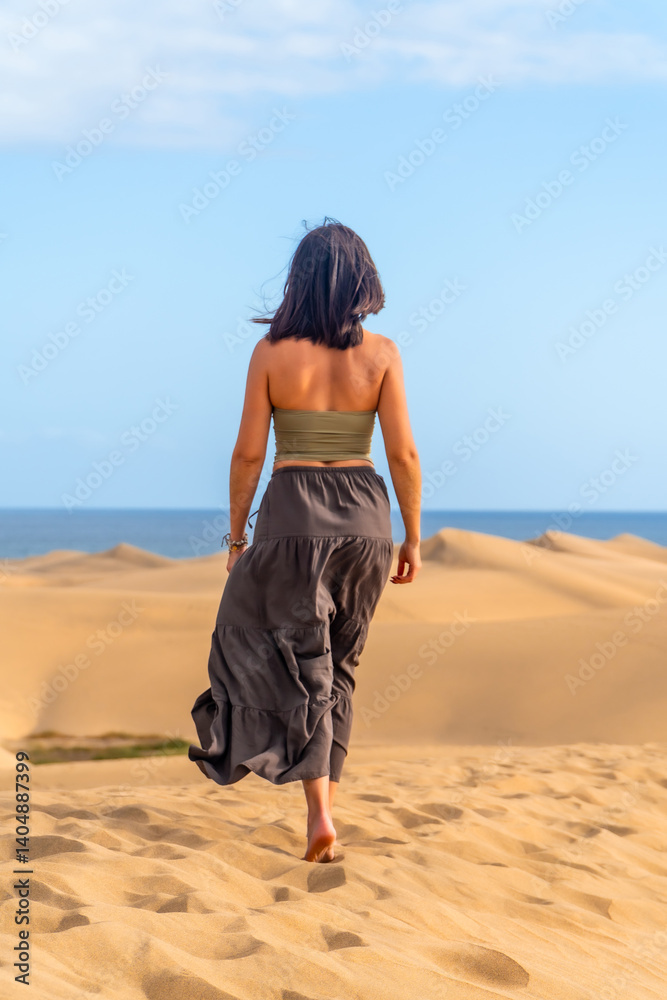 Tourist walking on maspalomas dunes in gran canaria, spain