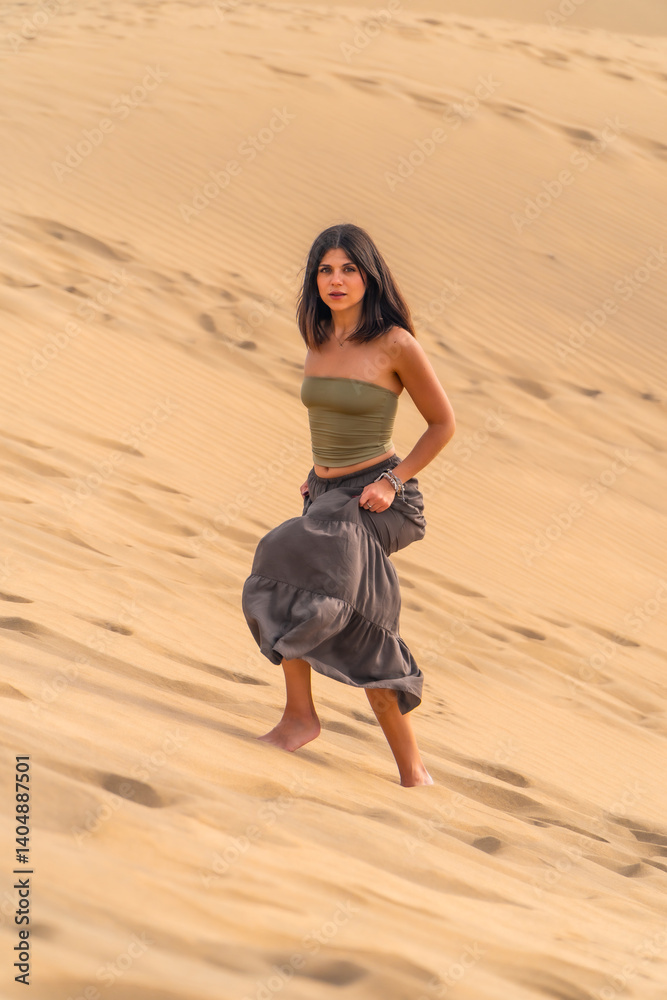 Tourist walking on maspalomas dunes in gran canaria