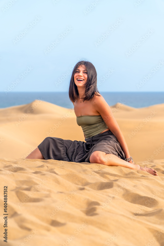 Tourist laughing in the maspalomas dunes, gran canaria, canary islands, spain