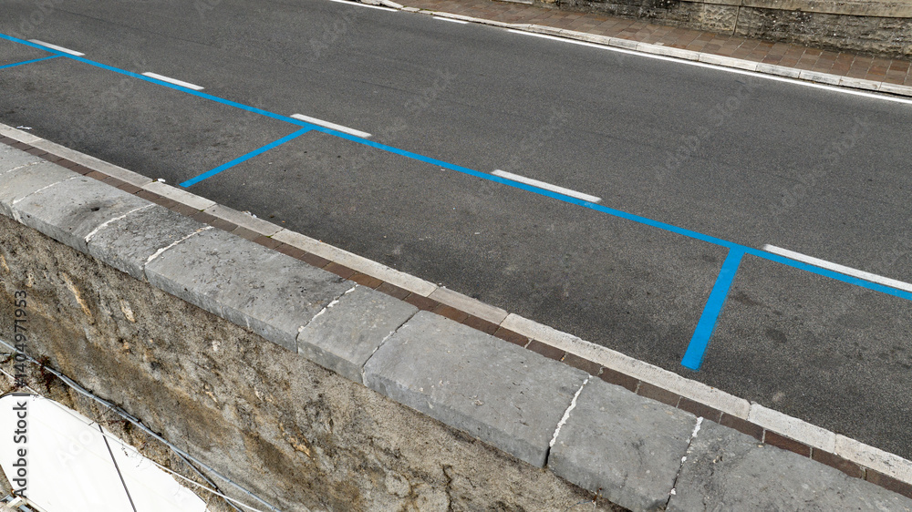 Closeup of a blue parking lot in Italy. The blue stripes indicate that parking is paid.