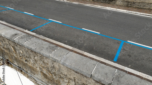 Obraz na płótnie Closeup of a blue parking lot in Italy. The blue stripes indicate that parking is paid. w salonie