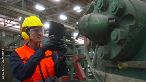 Professional asian man engineer and technician wearing safety helmet analyzing meeting with tablet in factory warehouse. Confident factory workers group inspection industry factory. Teamwork concept