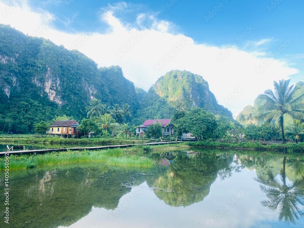 Fototapeta premium Lake and mountain. Karst mountain. Rammang Rammang Karst Mountain. landscape of Ramang-Ramang, a geological site, one of the biggest karst in the world. 