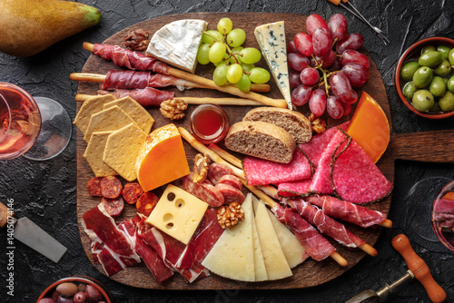 Wallpaper Mural Antipasti or tapas. Charcuterie and cheese board with wine, overhead flat lay shot on a black slate background. Mediterranean food and drinks Torontodigital.ca