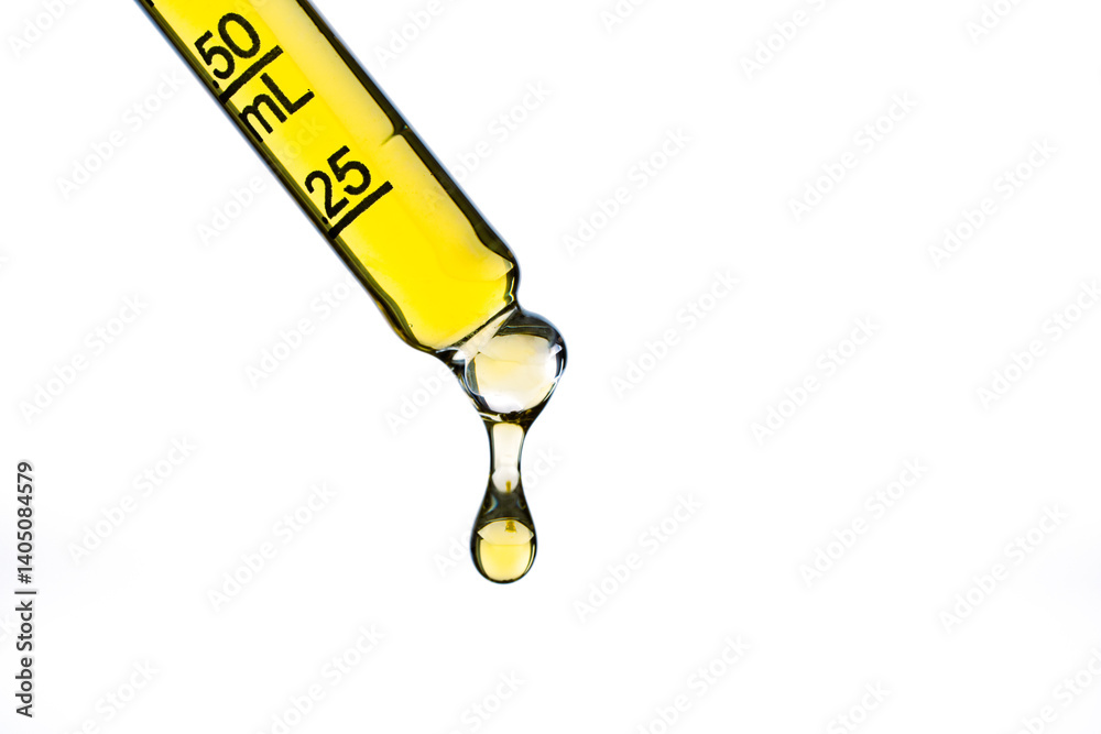 Yellow liquid in dropper on white background