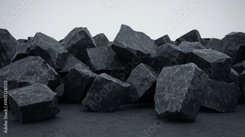 A pile of dark gray rocks with rough surfaces.