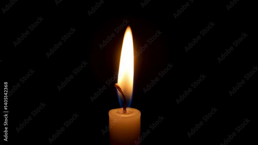 Candle flame glowing softly against a dark background Candle flame glowing softly against a dark background