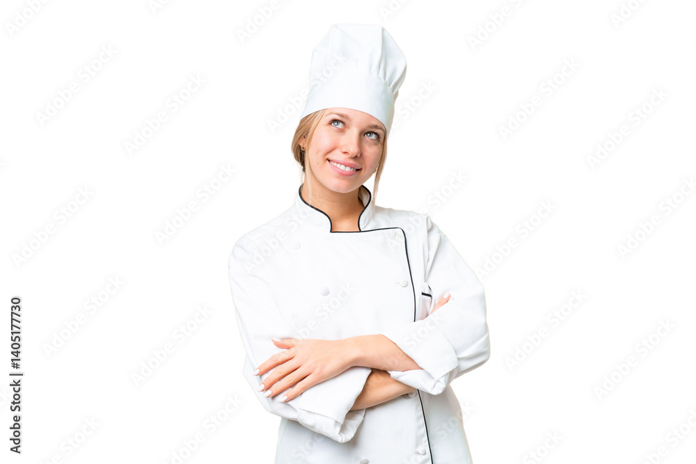 Young chef woman over isolated chroma key background looking up while smiling Young chef woman over isolated chroma key background looking up while smiling