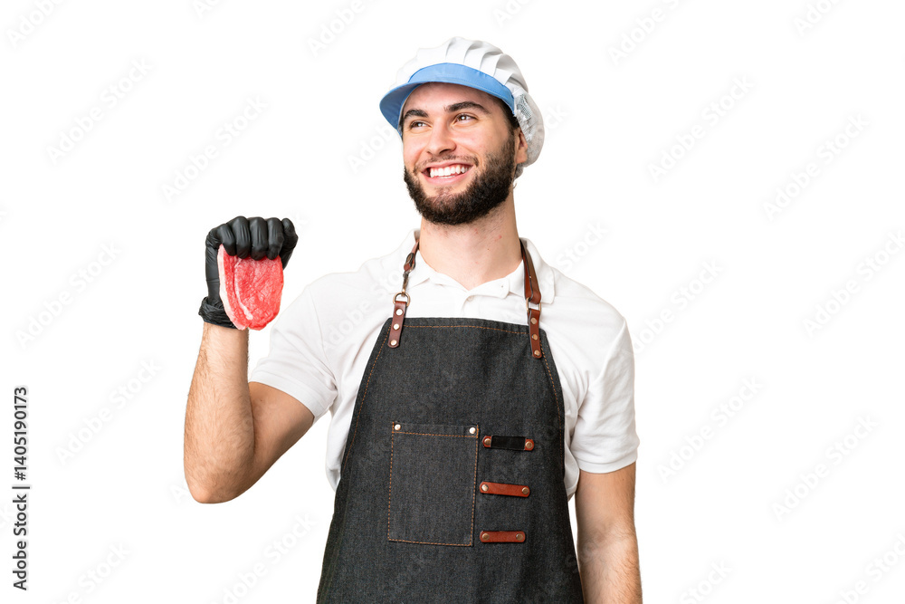 Butcher man wearing an apron and serving fresh cut meat over isolated chroma key background thinking an idea while looking up Butcher man wearing an apron and serving fresh cut meat over isolated chroma key background thinking an idea while looking up