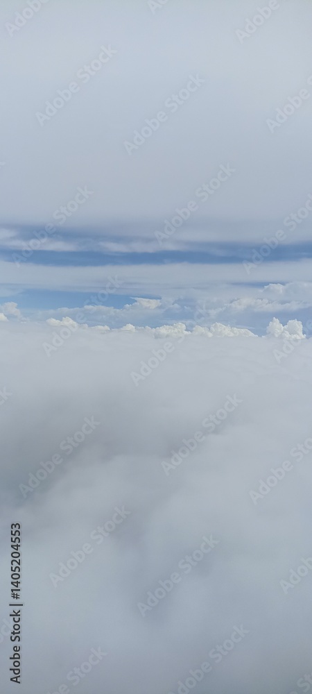 Serene View from Above the Clouds. A peaceful scene of fluffy white clouds, captured from an elevated perspective against a crisp blue sky, highlighting natural beauty Serene View from Above the Clouds. A peaceful scene of fluffy white clouds, captured from an elevated perspective against a crisp blue sky, highlighting natural beauty