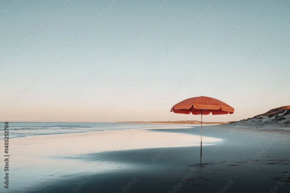 Solitary beach umbrella on a pristine, sandy shore.