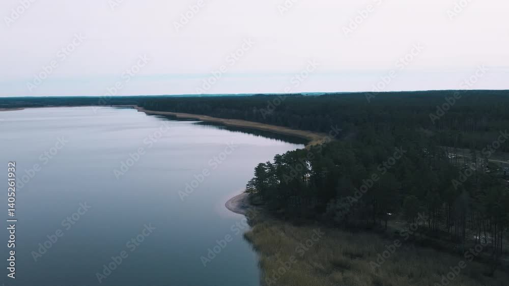 Aerial Drone View of Forest and Lake Shoreline at Dusk in Mazury, Poland Aerial Drone View of Forest and Lake Shoreline at Dusk in Mazury, Poland
