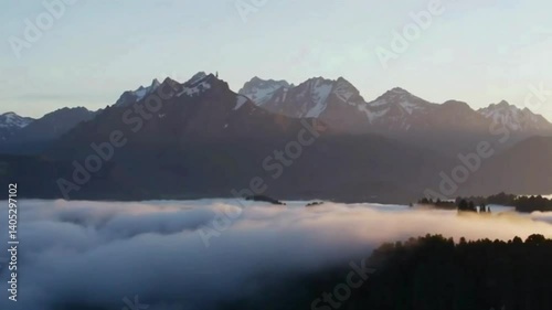 Sunrise over misty mountain range.