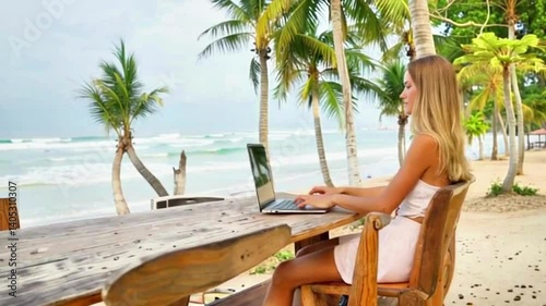 Woman works laptop tropical beach.