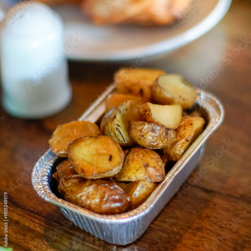 Obraz na plátně Roasted potato on aluminum foil on the table