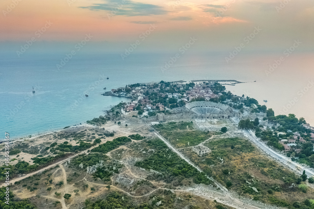 Side Ancient City in Antalya Province, Turkey. Aerial top drone view of the ancient Side town with amphitheater. Magnificent view.