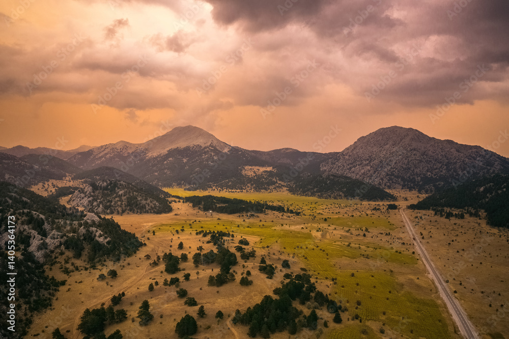 A valley surrounded by mountains in the Akseki district of Antalya. Cloudy and colorful skies and unique natural scenery. Antalya, Turkey.
