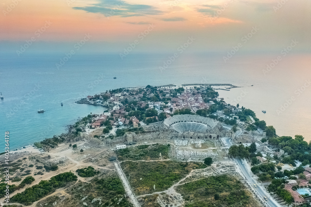 Side Ancient City in Antalya Province, Turkey. Aerial top drone view of the ancient Side town with amphitheater. Magnificent view.