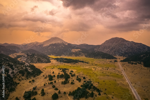Obraz na płótnie A valley surrounded by mountains in the Akseki district of Antalya. Cloudy and colorful skies and unique natural scenery. Antalya, Turkey. w salonie