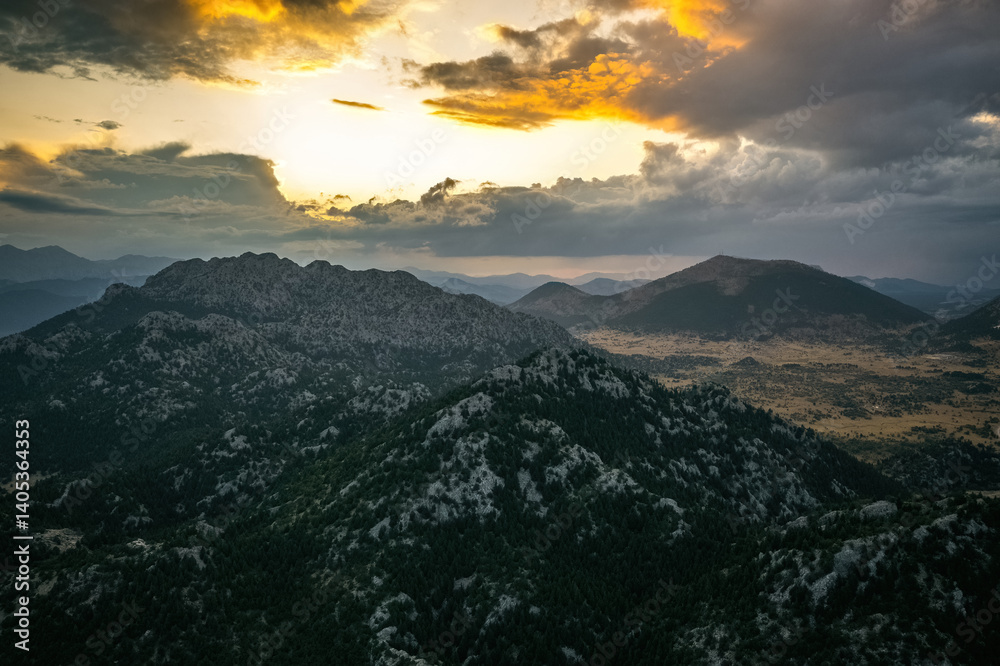 The magnificent big mountains covered with trees in Akseki district of Antalya. The sun is illuminating the sky from between the clouds.