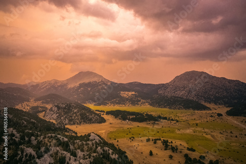 Obraz na płótnie A valley surrounded by mountains in the Akseki district of Antalya. Cloudy and colorful skies and unique natural scenery. Antalya, Turkey. w salonie