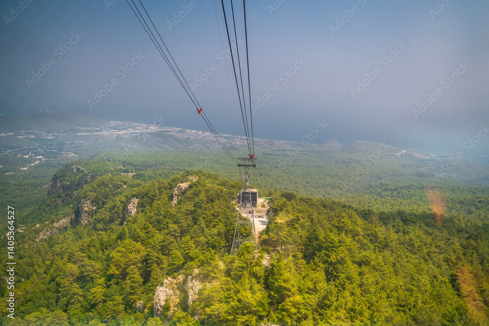 Cable car moving down from the summit of Tahtali Mountain in Antalya province of Turkey. The cabin goes down. Lush forest view.
