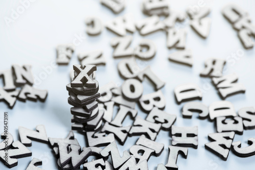 Bled natural wooden letters of the English alphabet in chaotic order on the blue surface.