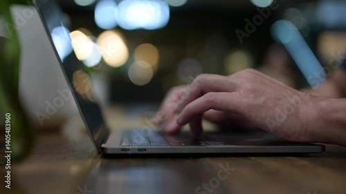 Close up of a hands on a laptop keyboard blur bokeh background. searching data networks or chatting online. typing sending message input data and data analysis