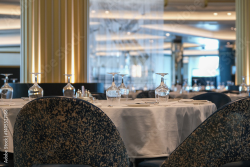Obraz na płótnie Formal and elegant ocean view dining room restaurant onboard luxury cruiseship or cruise ship liner with set tables in Art Deco interior design style and ceiling ambient lighting w salonie