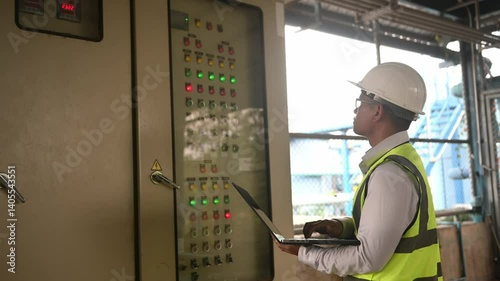 Electrical engineers check the operation of machines through electrical switchboards in a waterworks plant.