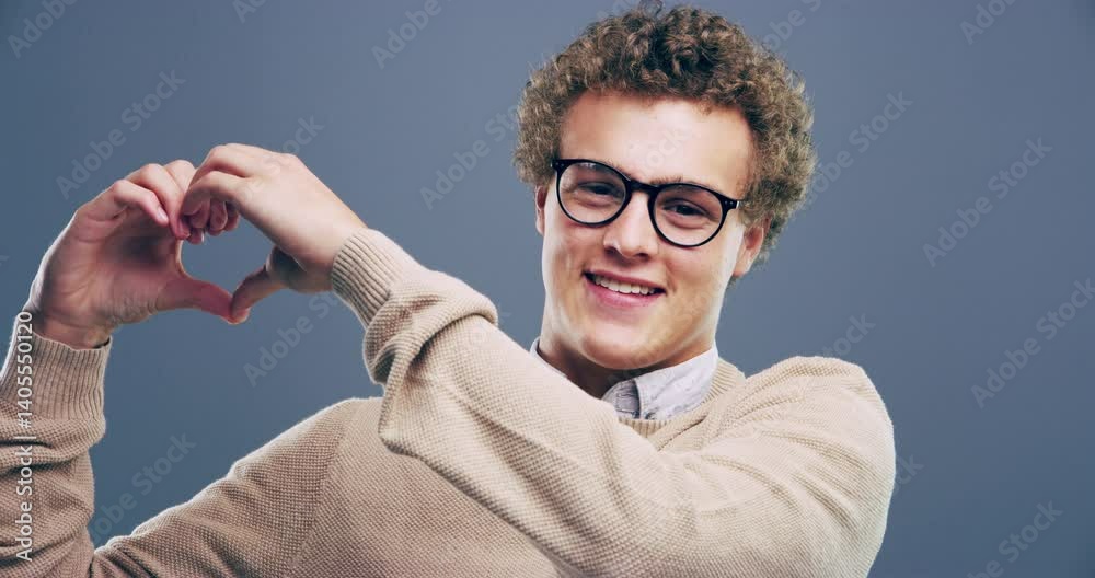Heart, hands and face of man with love, sign and shape in studio and gray background with nerd. Like, symbol or icon in portrait of geek to show kindness, happiness or emoji of care and support