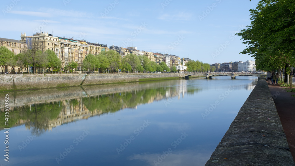 The city of Donostia-San Sebastián is reflected in the Urumea river, Euskadi