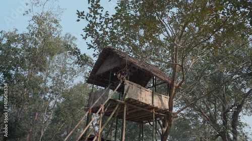 Awide shot of a bamboo tree house in Assam
