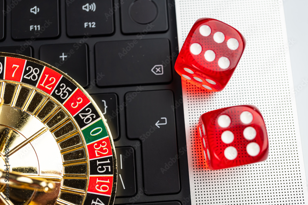 Obraz premium Image depicts an online gambling scene, with a laptop displaying a casino game interface, suggesting a roll-based game like craps Physical dice and keyboard symbolize interaction between digital and
