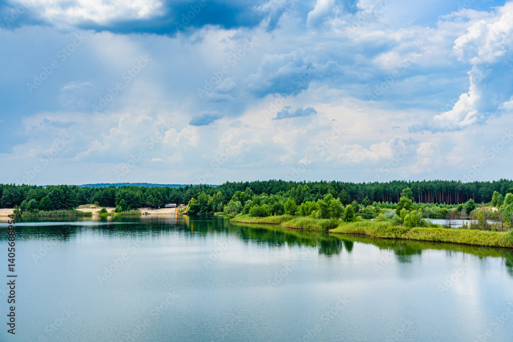 View on a lake in the abandoned sand quarry and dramatic sky View on a lake in the abandoned sand quarry and dramatic sky