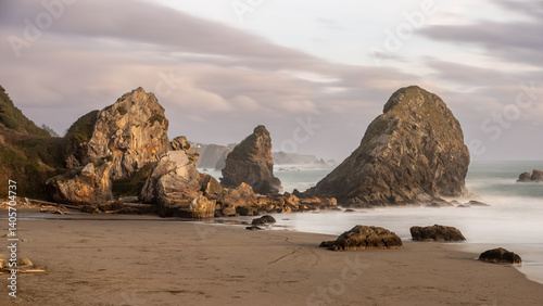 Waves crash into large haystack rocks along the Oregon Coast photo